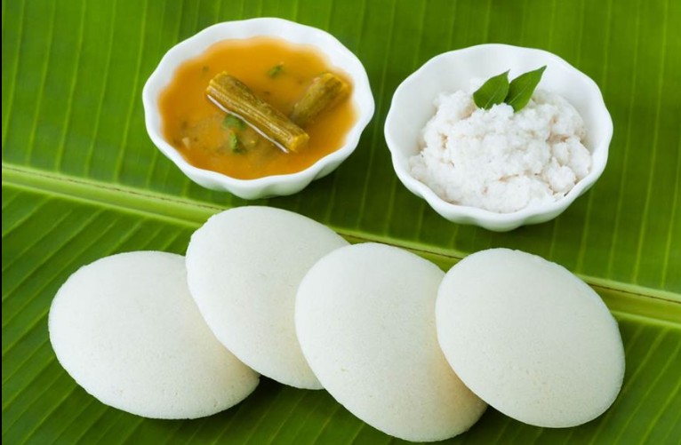 Soft fluffy steamed Idli served with authentic sambar and coconut chutney