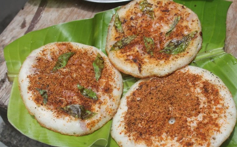Spicy Podi Uttapam topped with traditional gun powder masala and ghee